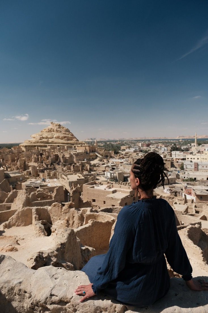 Tolo seated on the Shali Fortress ruins overlooking Siwa Oasis